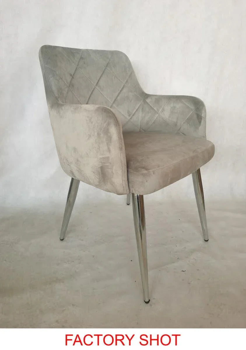 Grey velvet dining chair with quilted backrest and chrome legs on plain background