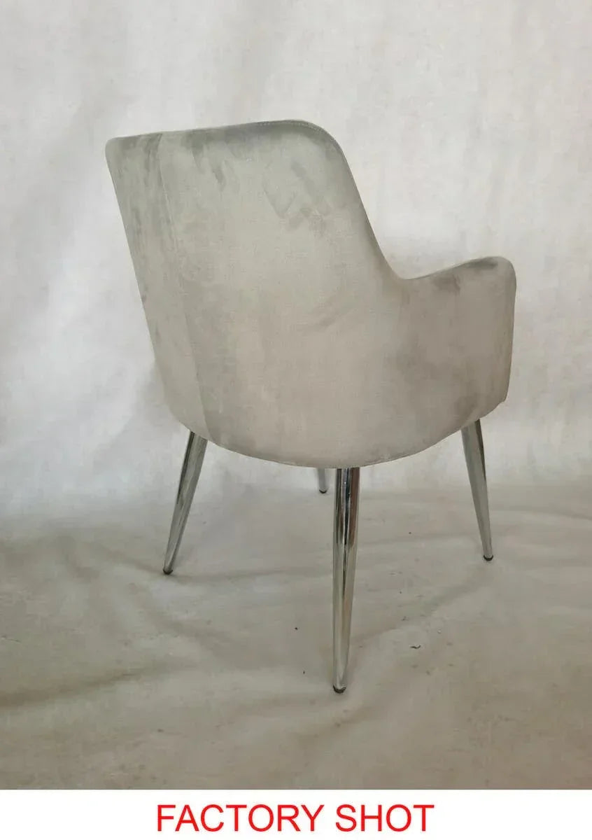 Light grey upholstered dining chair with curved back and chrome legs, rear angle view