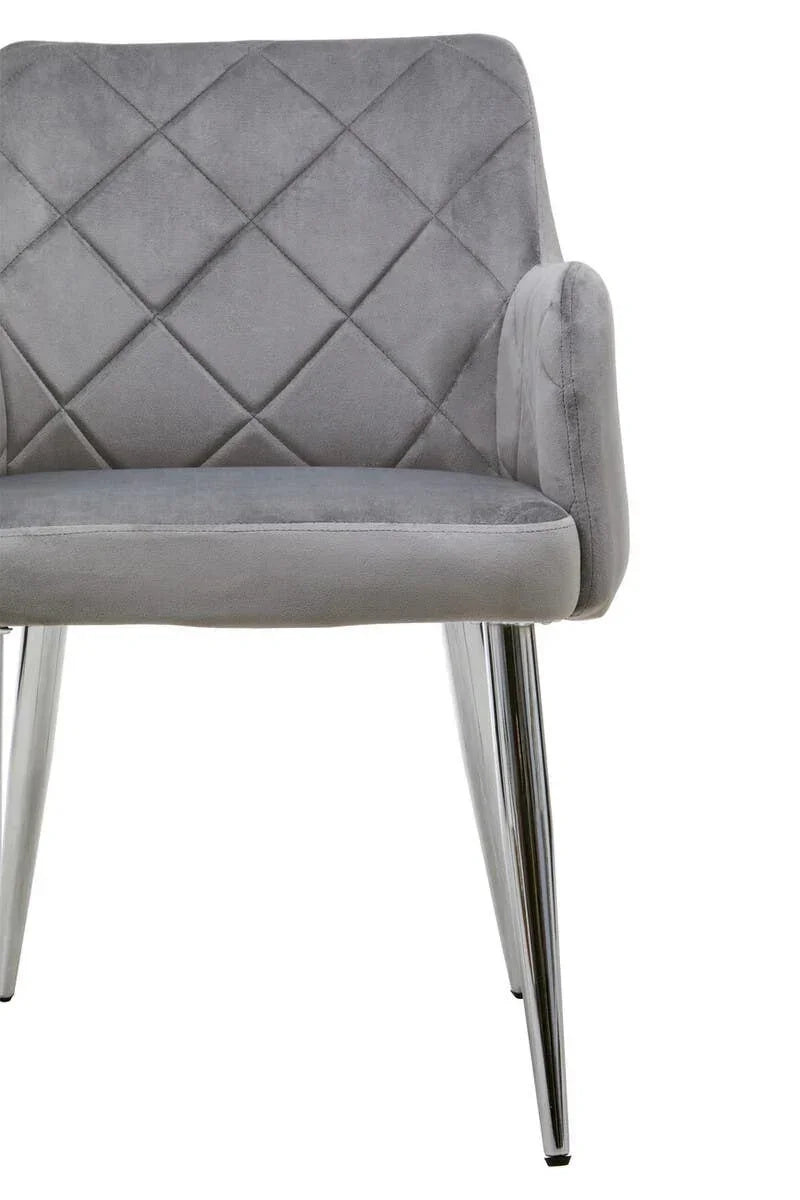 Grey velvet dining chair with diamond quilted back and chrome legs, front angled view