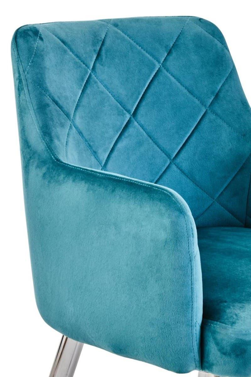 Blue velvet accent chair with diamond stitched backrest and chrome legs, close-up view