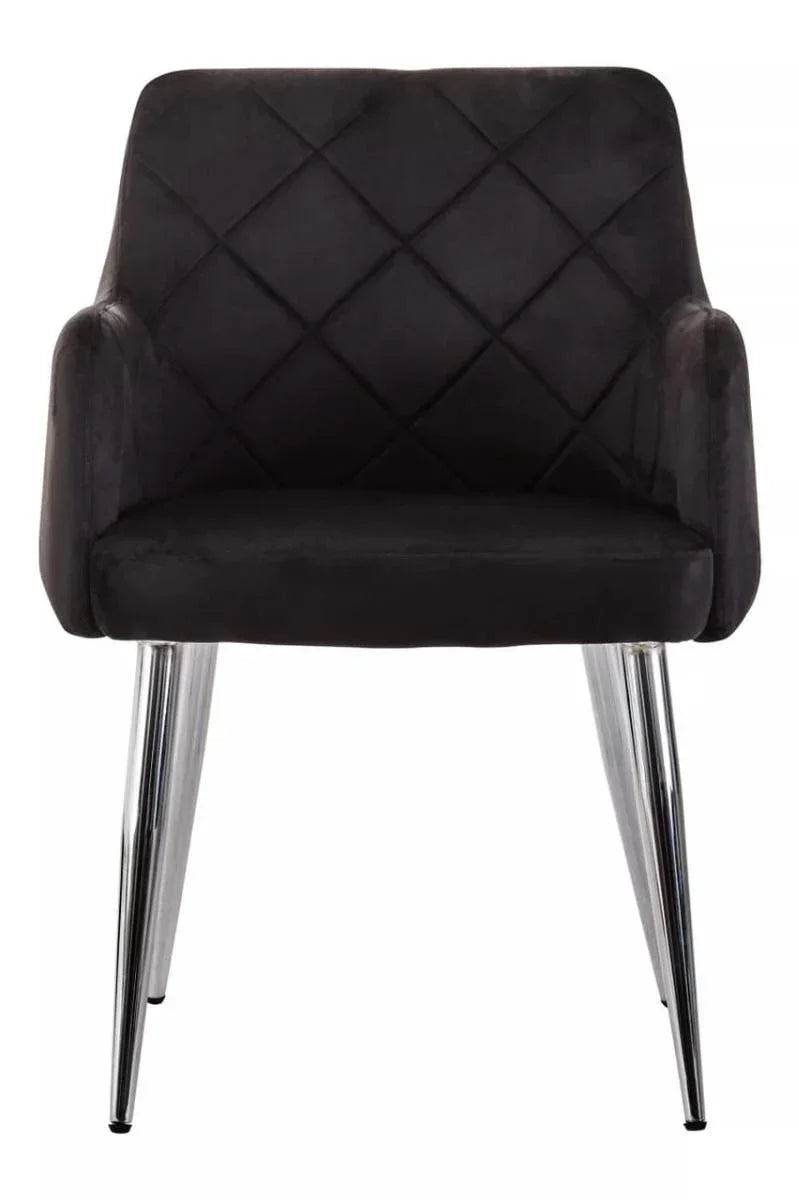 Black velvet dining chair with quilted backrest and chrome legs, front view