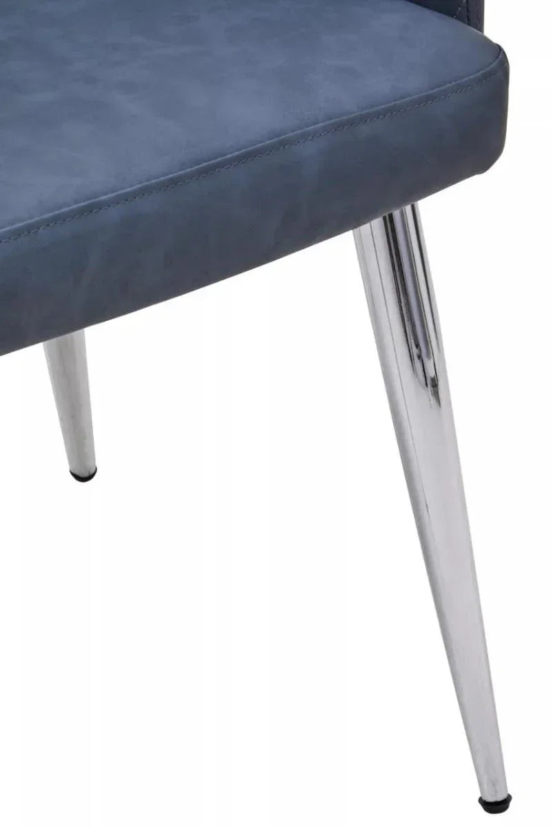 Blue upholstered dining chair seat with chrome metal legs, close-up view