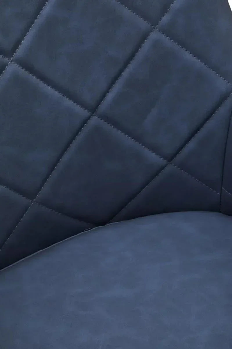 Close-up of blue upholstered dining chair with diamond stitched backrest