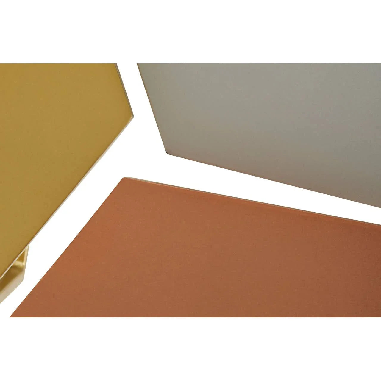 Set of nesting tables with gold, beige, and terracotta tabletops, close-up angle