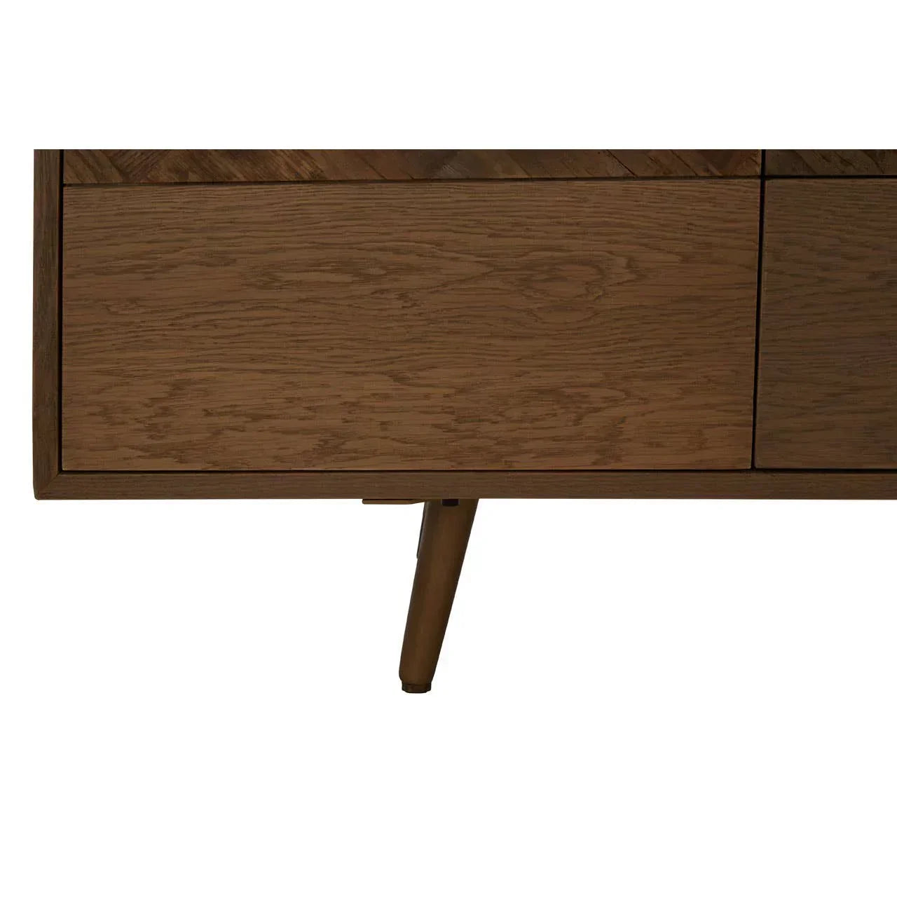 Closeup of oak sideboard with natural wood grain and angled mid-century leg