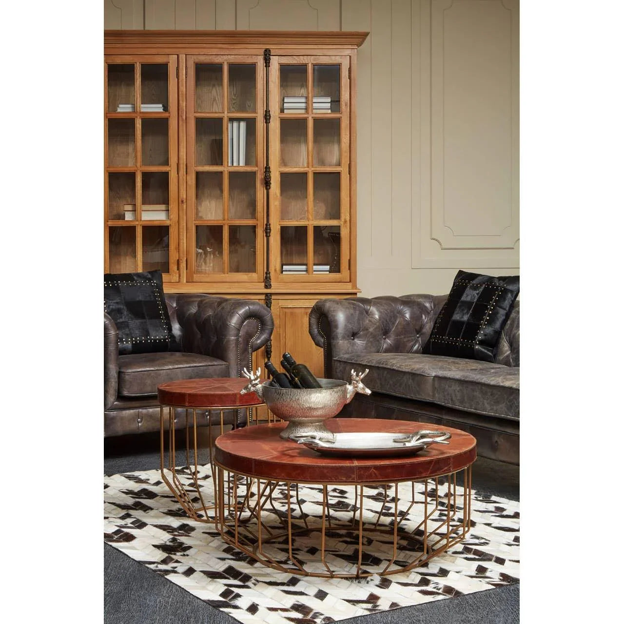 Brown leather sofa and round coffee table with metal base in living room