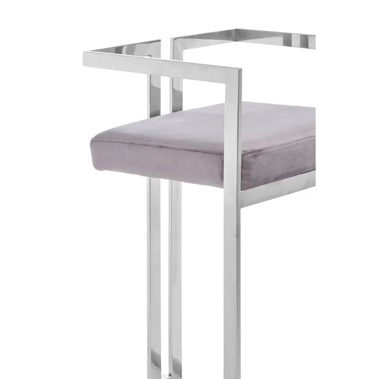 Modern bar stool with chrome frame and grey velvet seat, close-up side angle