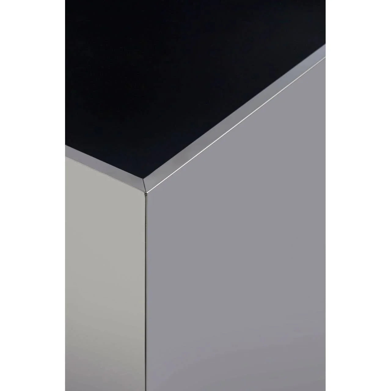 Close-up of corner on modern chrome and black glass coffee table