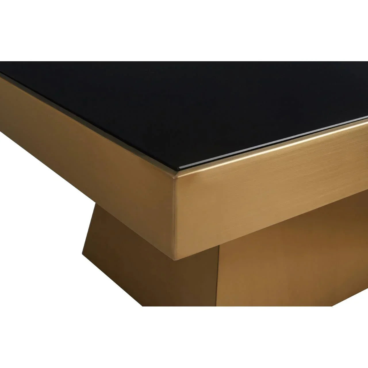 Black glass dining table with gold metal frame and pedestal base close-up