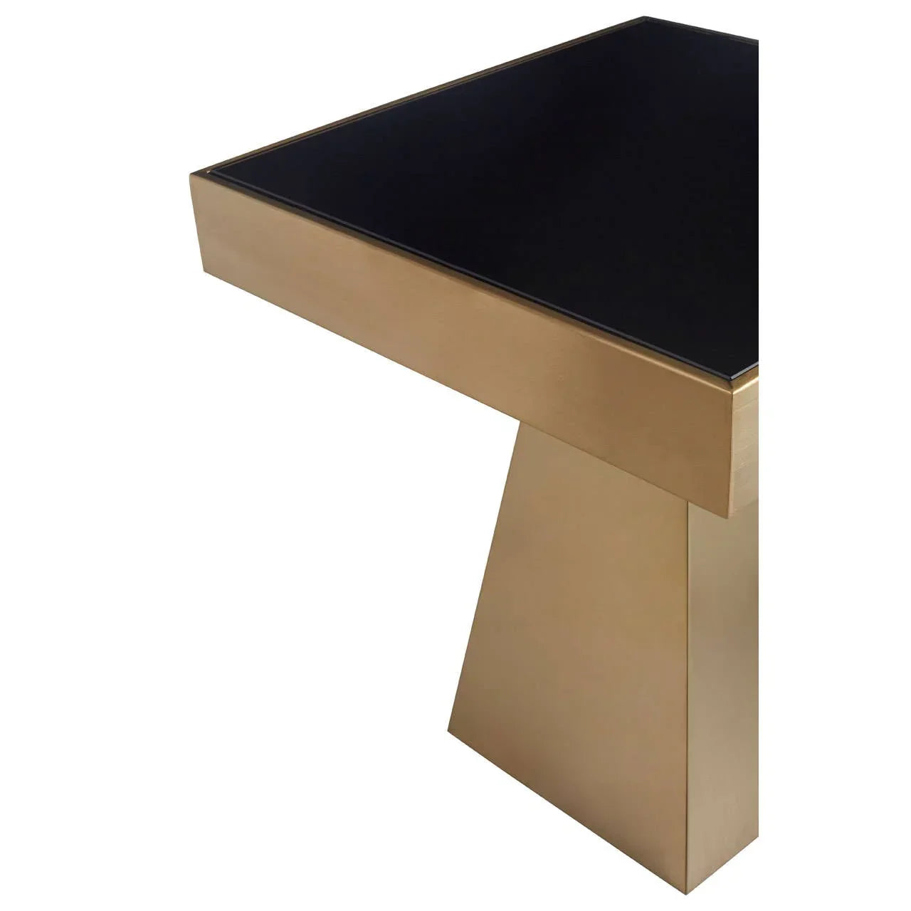 Modern dining table corner with black glass top and brushed gold metal base