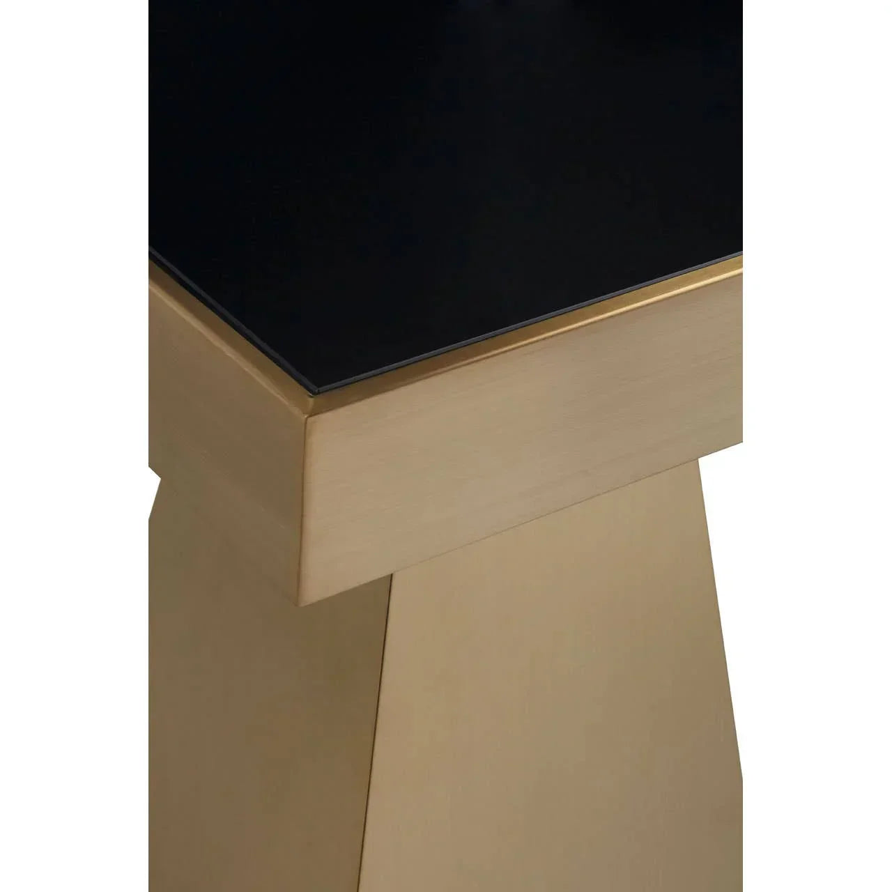 Close up of gold pedestal table base with black glass tabletop