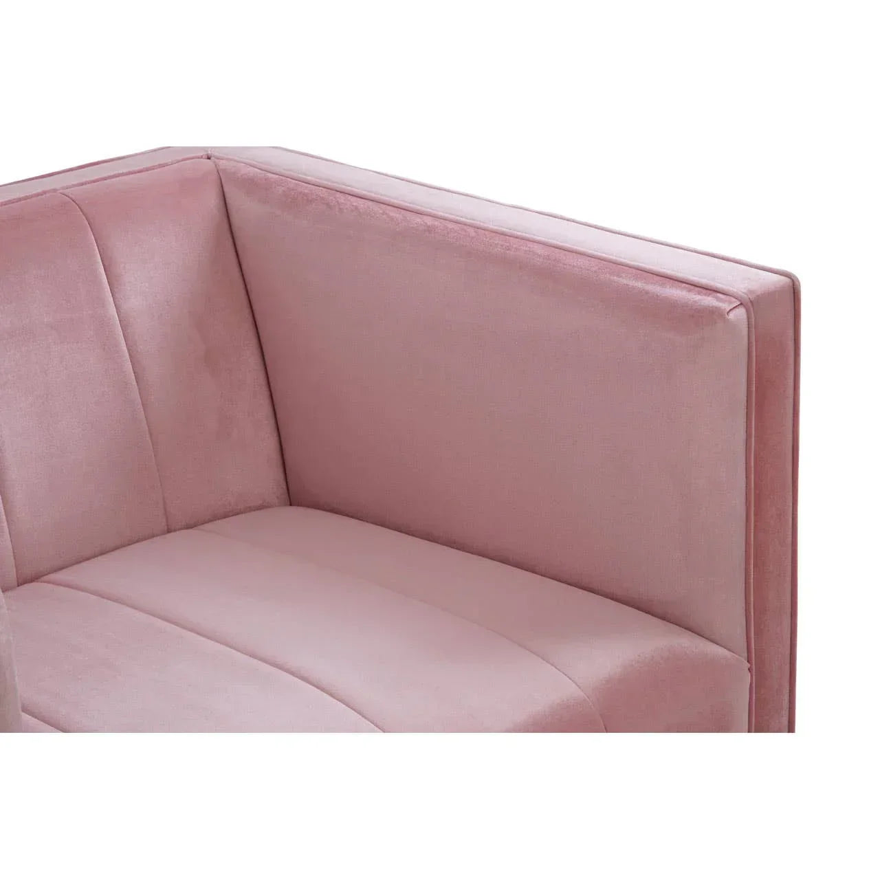 Close up of pink velvet sofa corner with padded back and seat upholstery