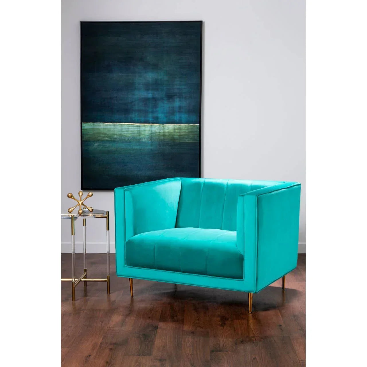Turquoise velvet armchair with gold legs in modern living room with artwork