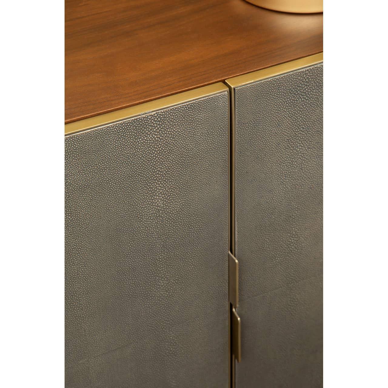 Textured cabinet doors with gold trim and wooden top, close-up on furniture detail