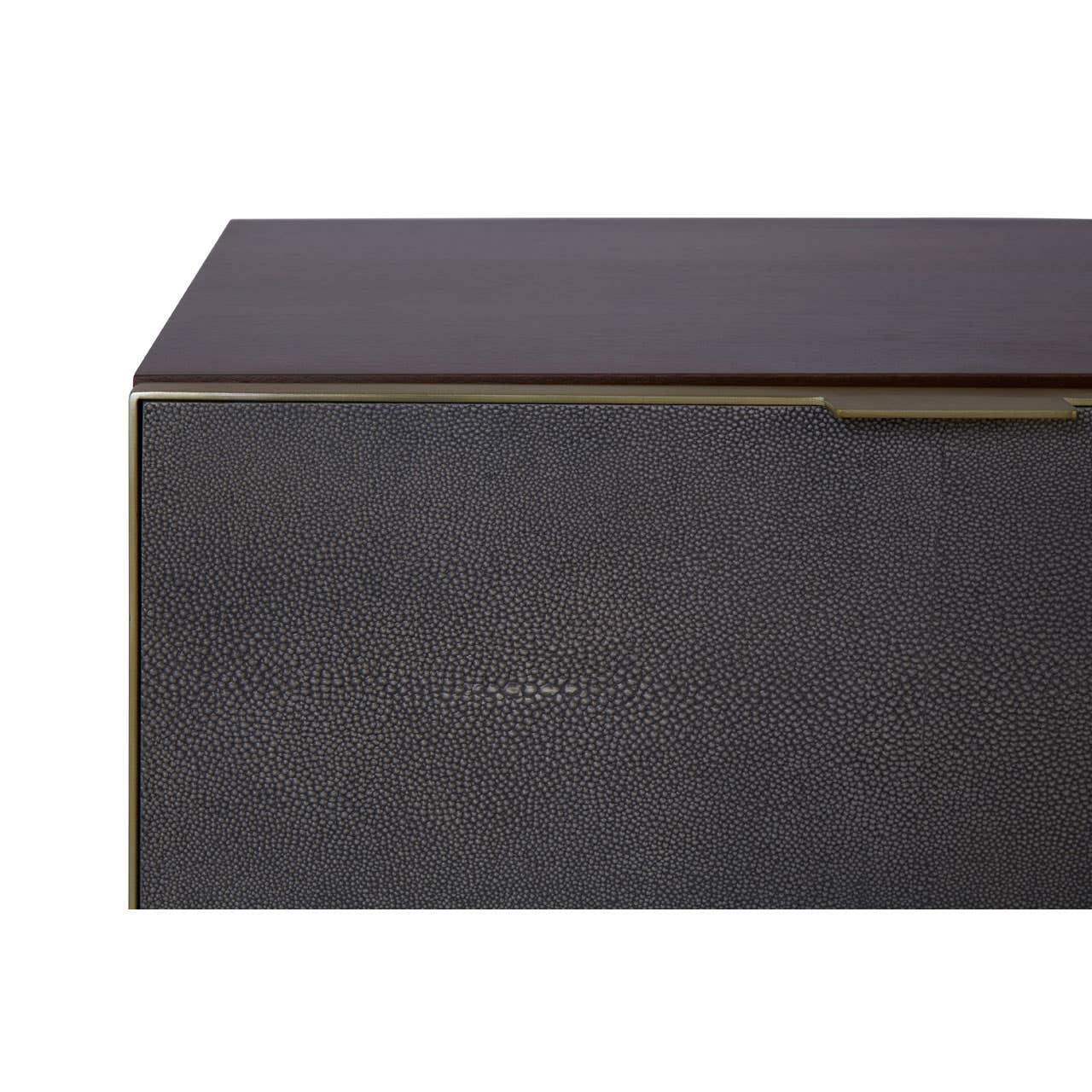 Dark wood sideboard with textured black drawer front and gold trim, close-up view
