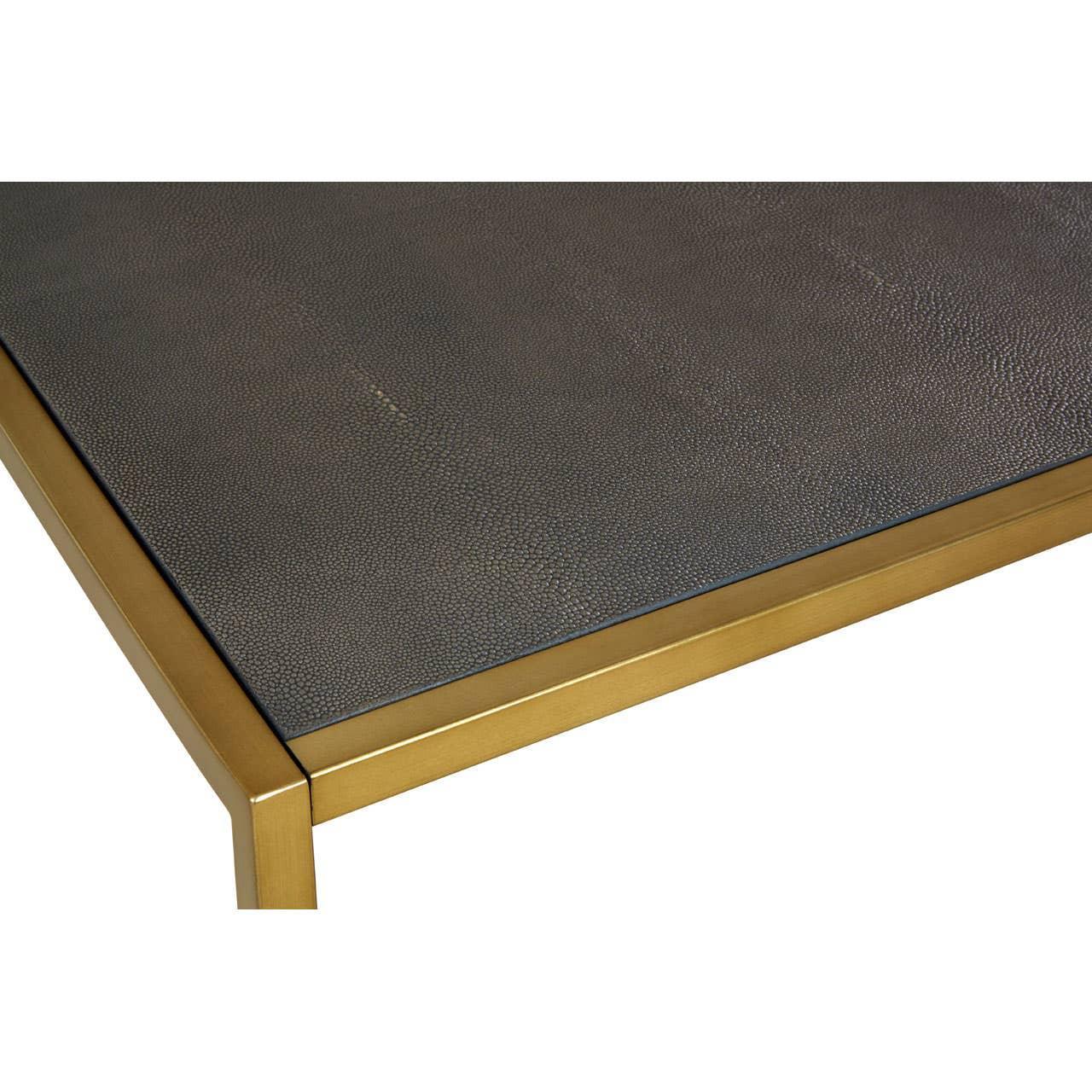 Closeup of coffee table with textured black surface and gold metal frame