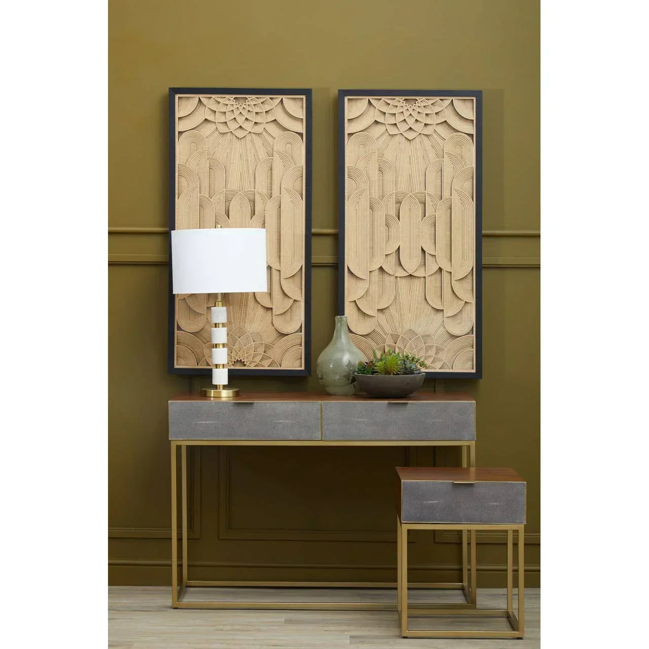 Contemporary console table with gold metal frame, decorative wall art, lamp, and vase