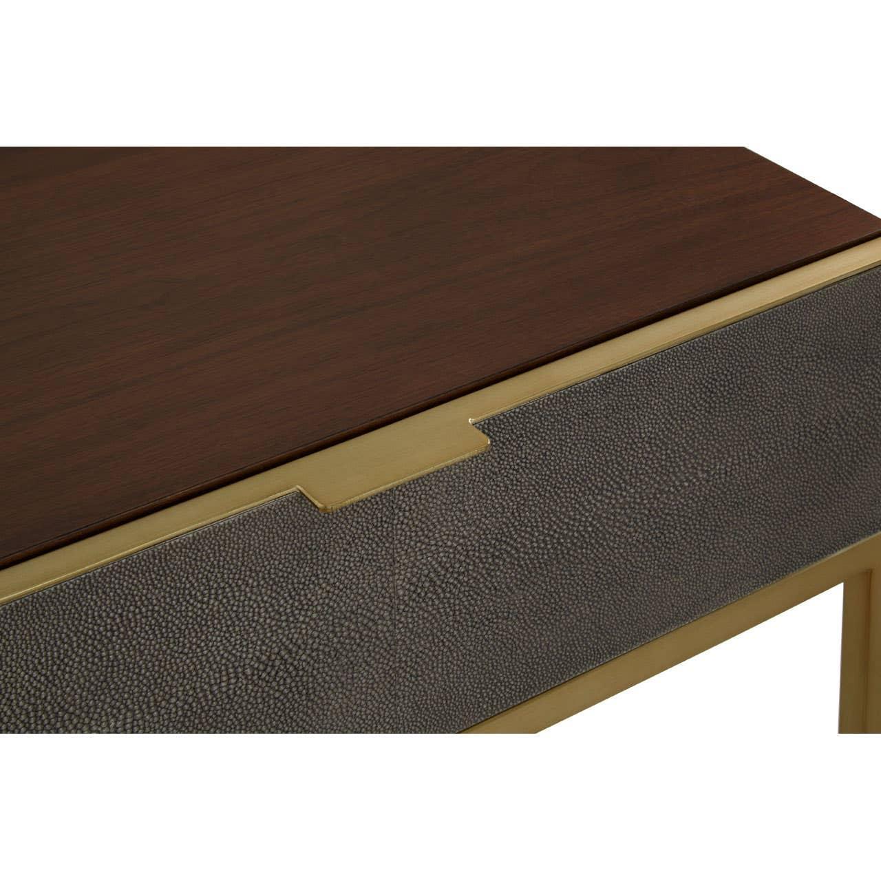 Close view of console table with dark wood top, textured drawer front and gold trim