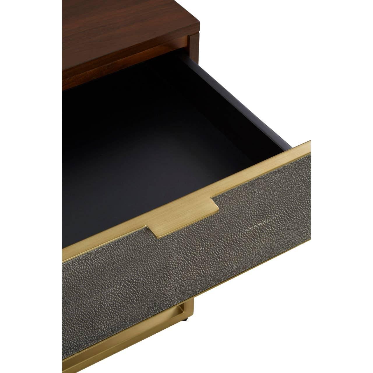 Closeup of a modern drawer unit with brass textured front and dark wood top