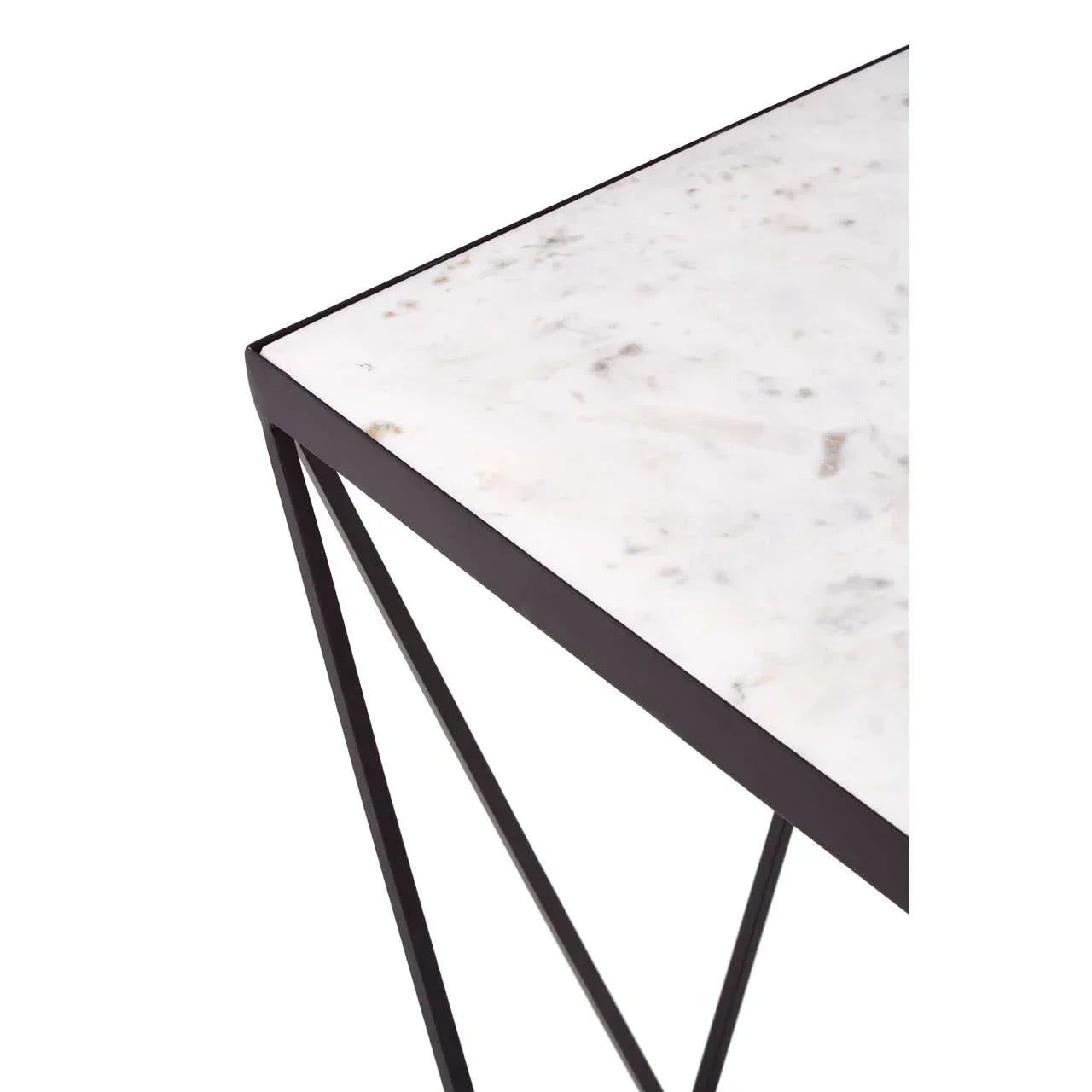 Corner view of marble top table with black metal frame and modern geometric legs