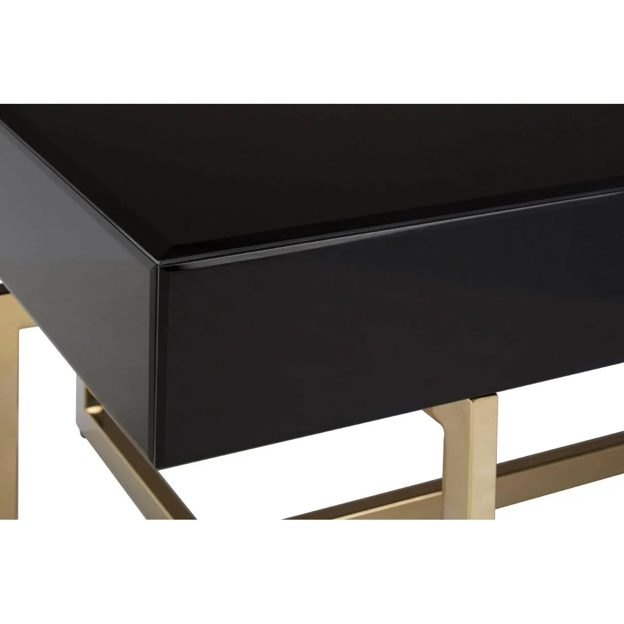 Black coffee table with gold metal legs, close-up of glossy top and frame detail