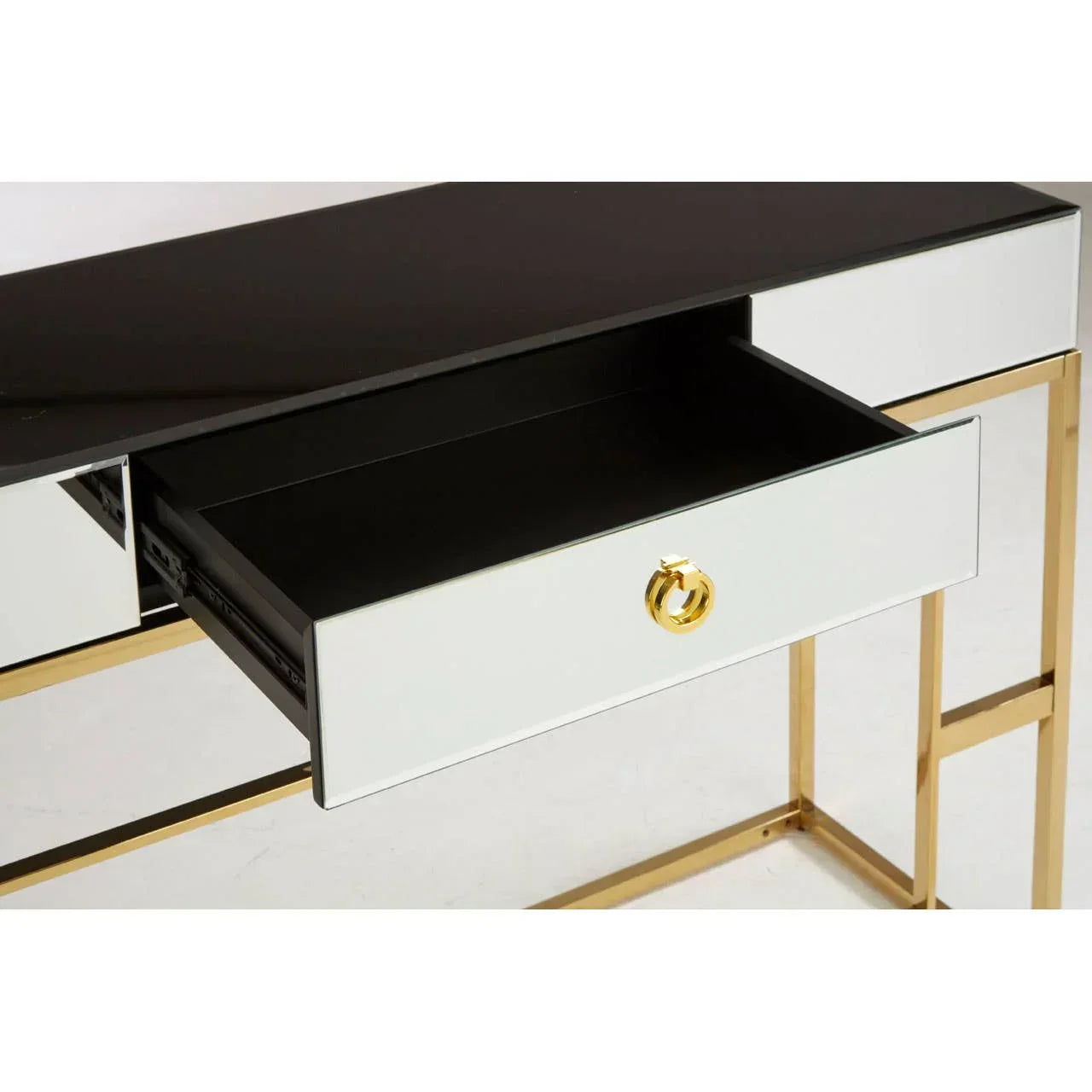 Mirrored console table with gold metal frame and single open drawer