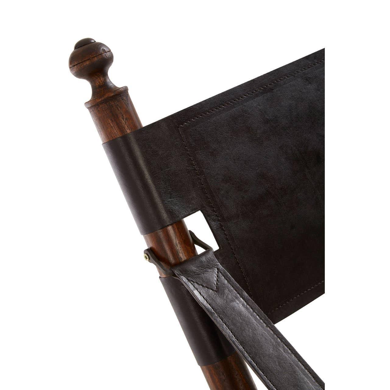 Closeup of wooden chair frame with dark brown leather backrest