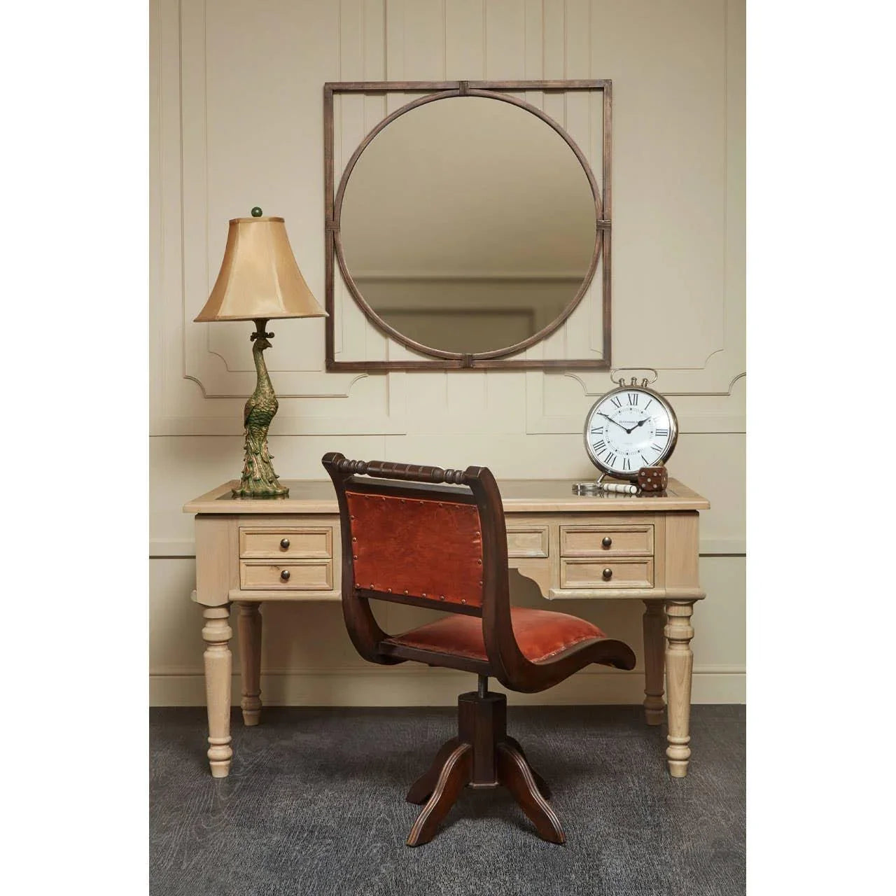 Leather office chair with wood frame and tan desk in vintage home office setting