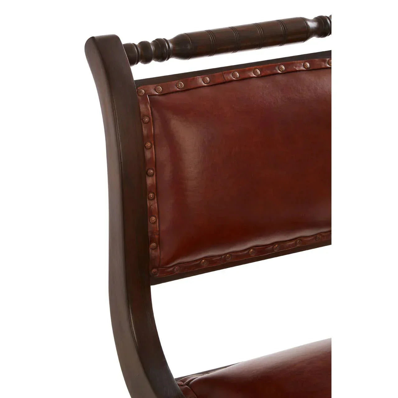 Closeup of wooden dining chair with brown leather upholstered backrest and stud detailing