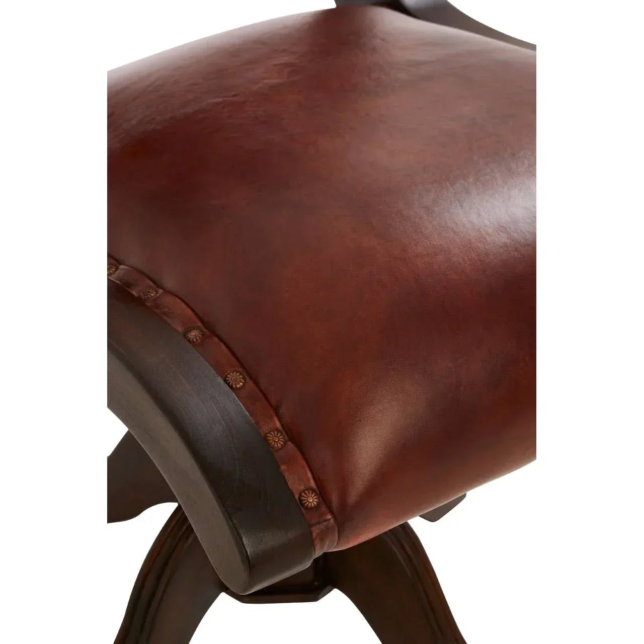 Close-up of brown leather dining chair seat with decorative studs and dark wooden legs