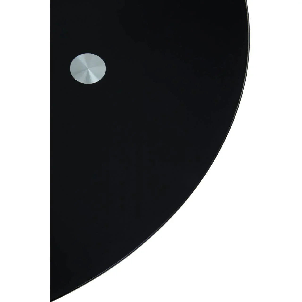 Black glass tabletop with round metallic detail, close-up of modern dining table surface