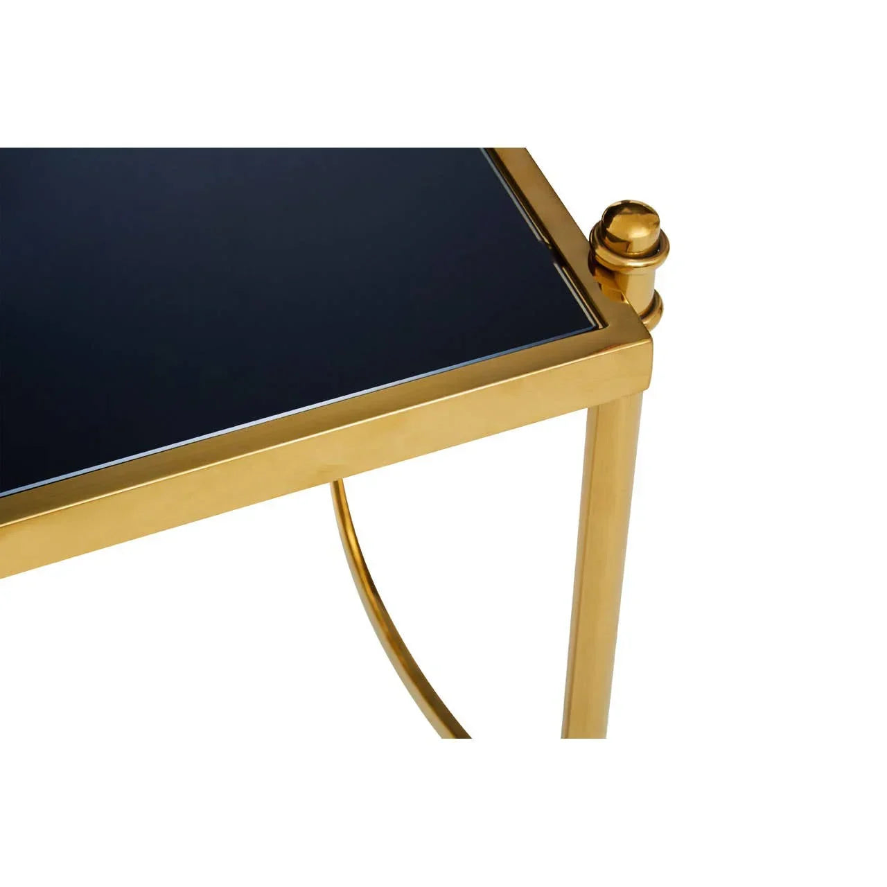 Gold metal side table with black glass top corner detail