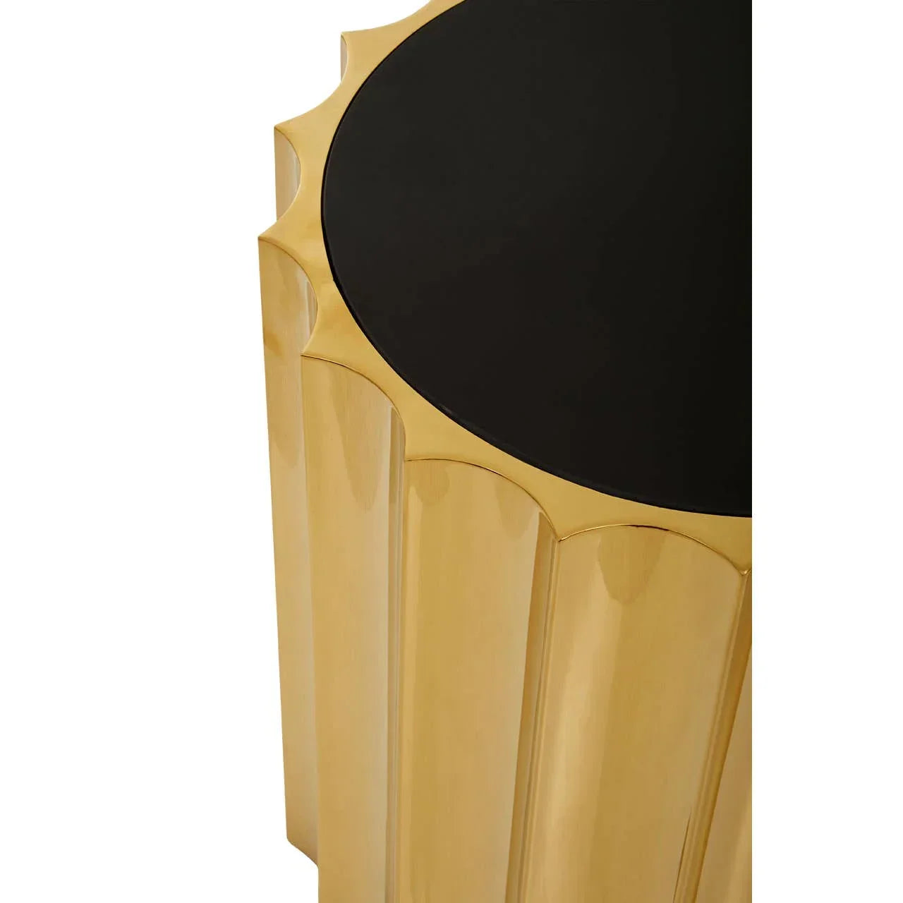 Gold side table with black circular top and scalloped edge detail