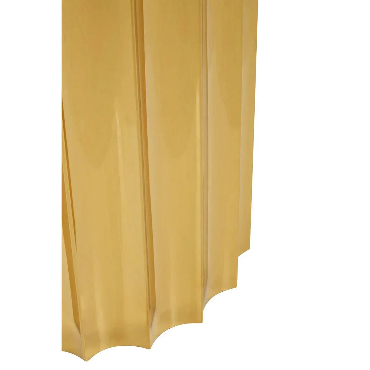 Gold metal panel with vertical ridges and scalloped edge, close-up view