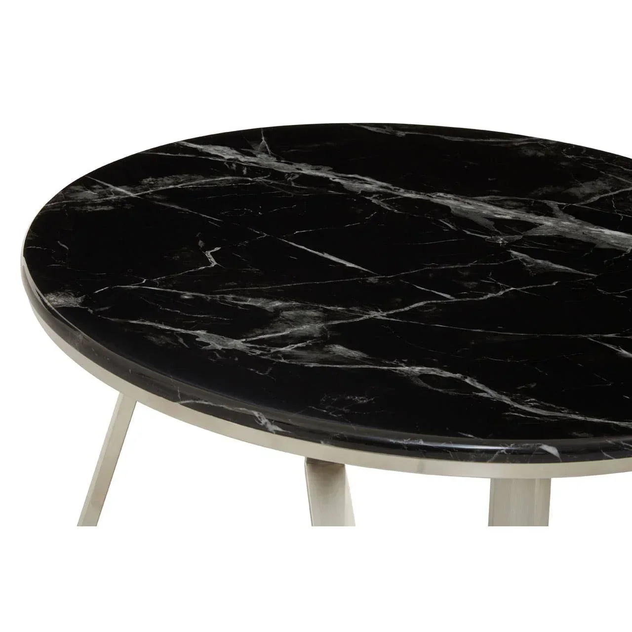 Round black marble dining table with metal legs, close-up of tabletop and edge