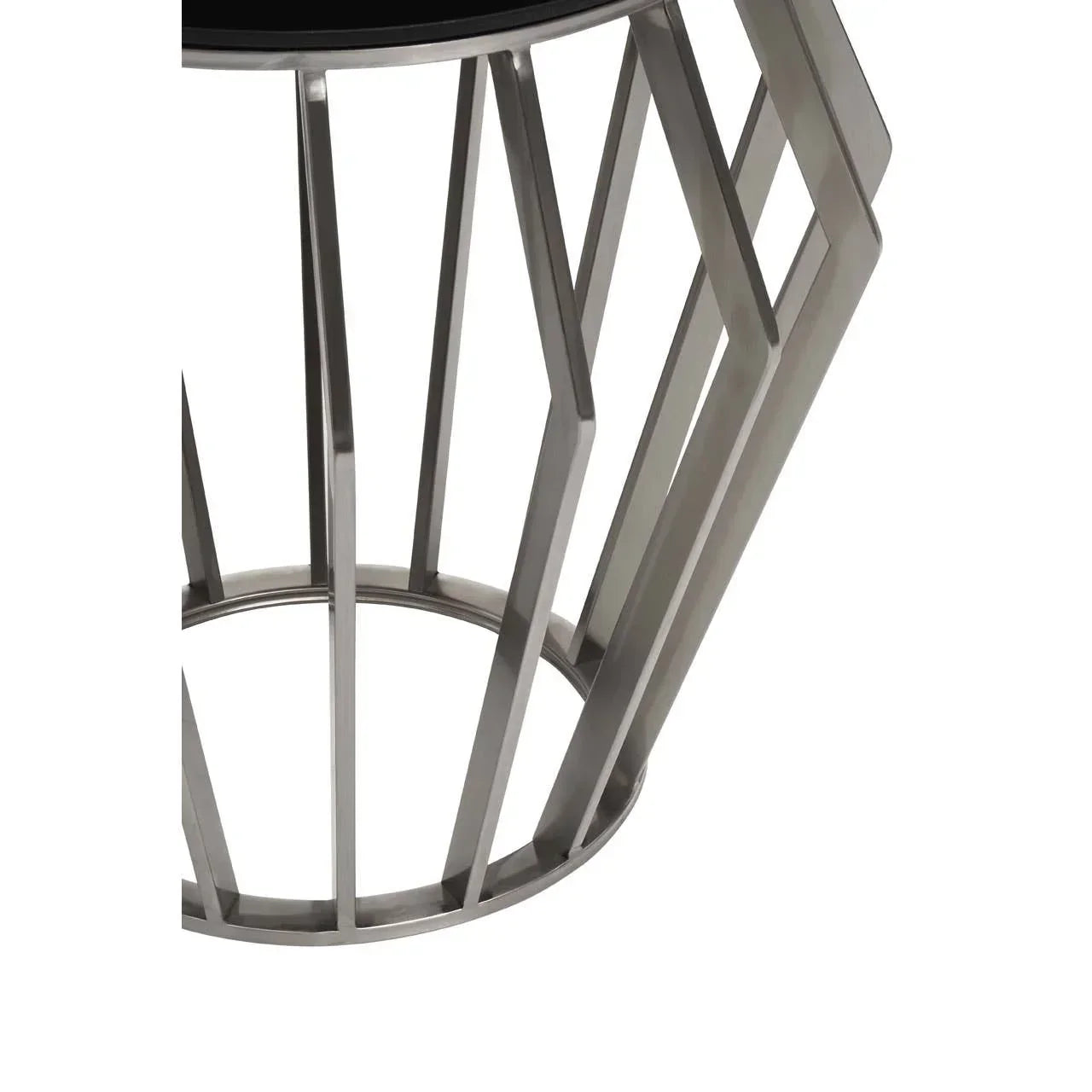 Close view of metal side table base with geometric pattern and round black tabletop