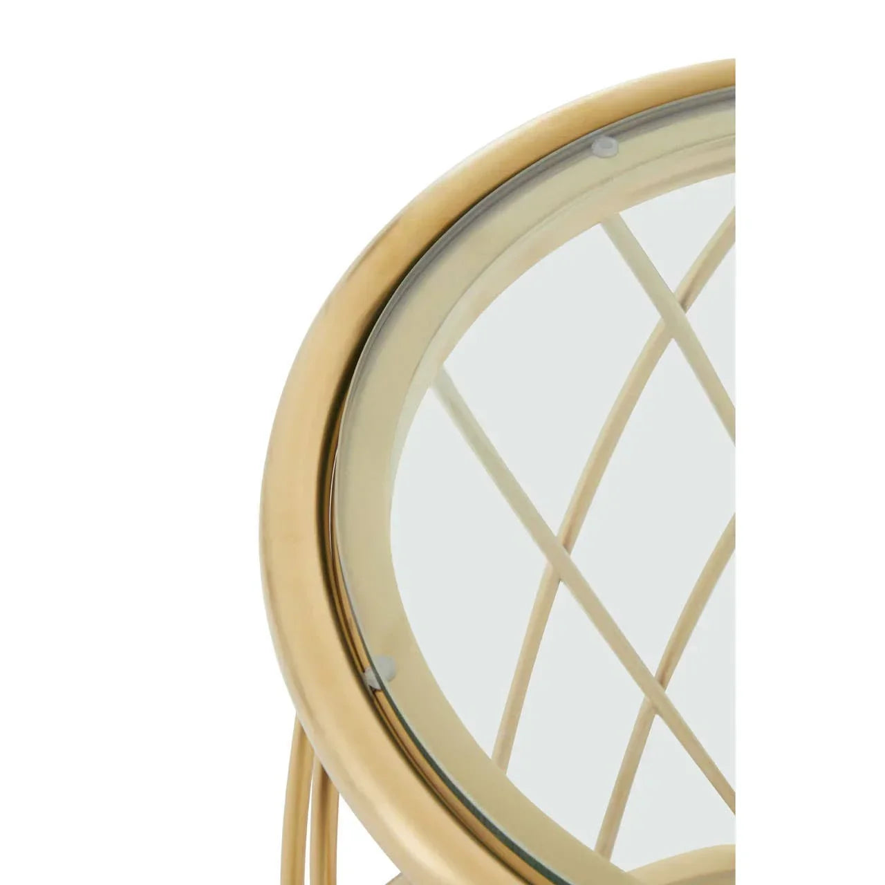 Gold metal side table with glass top and crisscross base detail, partial close-up view