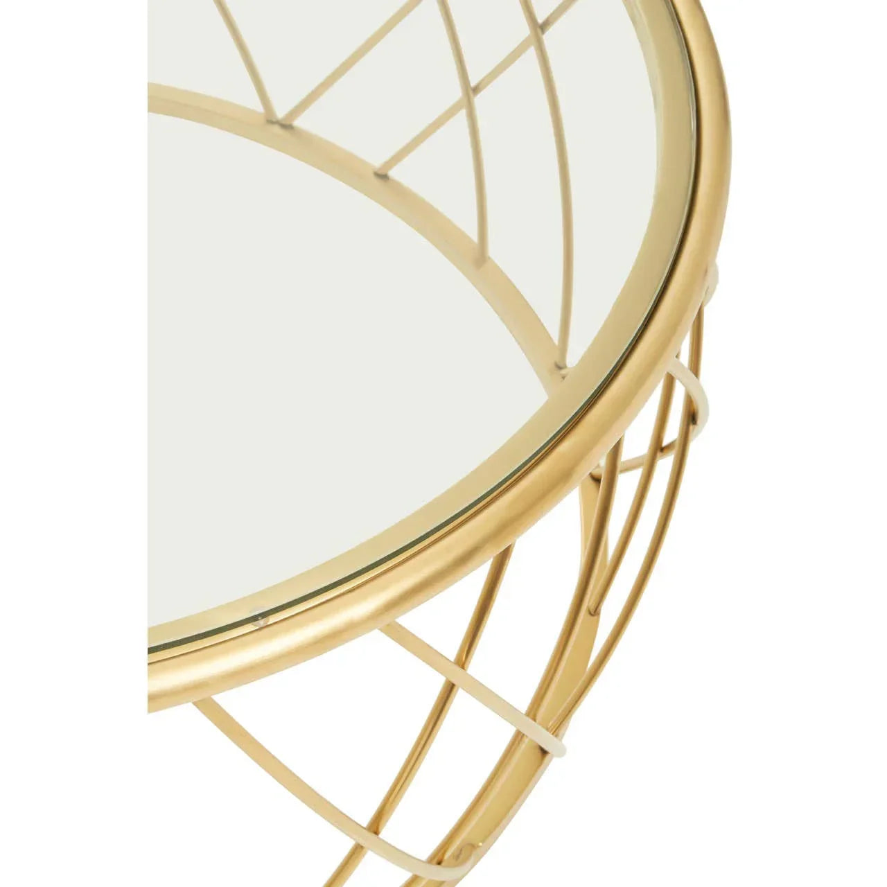 Gold metal side table with round glass top and wire frame detail, top angled view