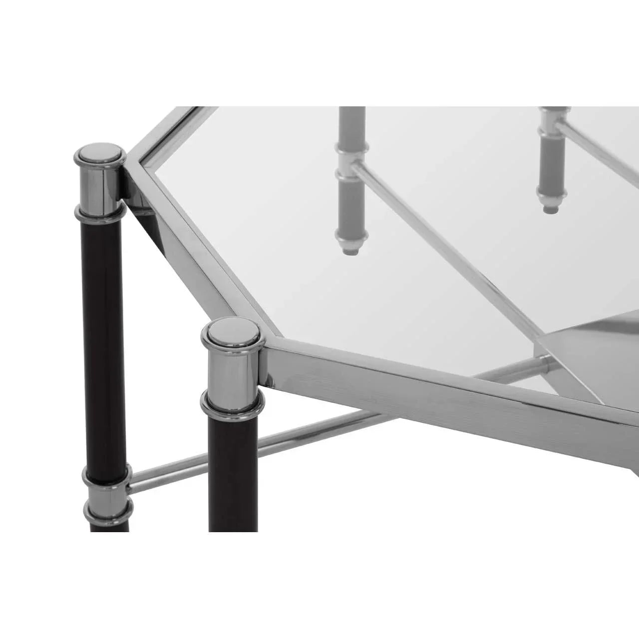 Hexagonal glass coffee table with chrome frame and black legs, close-up corner view