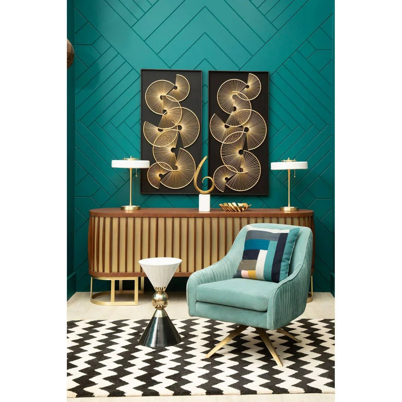Velvet accent chair with geometric cushion, gold sideboard, and chevron rug in modern living room