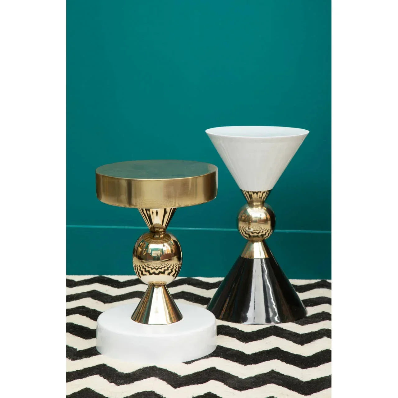 Gold and white modern accent tables with geometric bases on black and white chevron rug