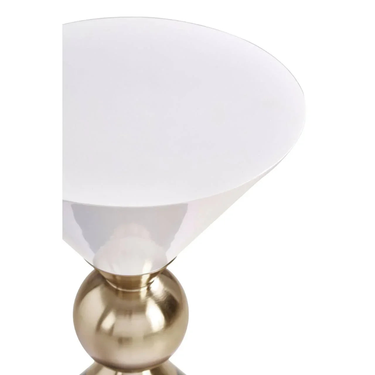 Round side table with white top and gold metallic base, close-up of modern furniture design