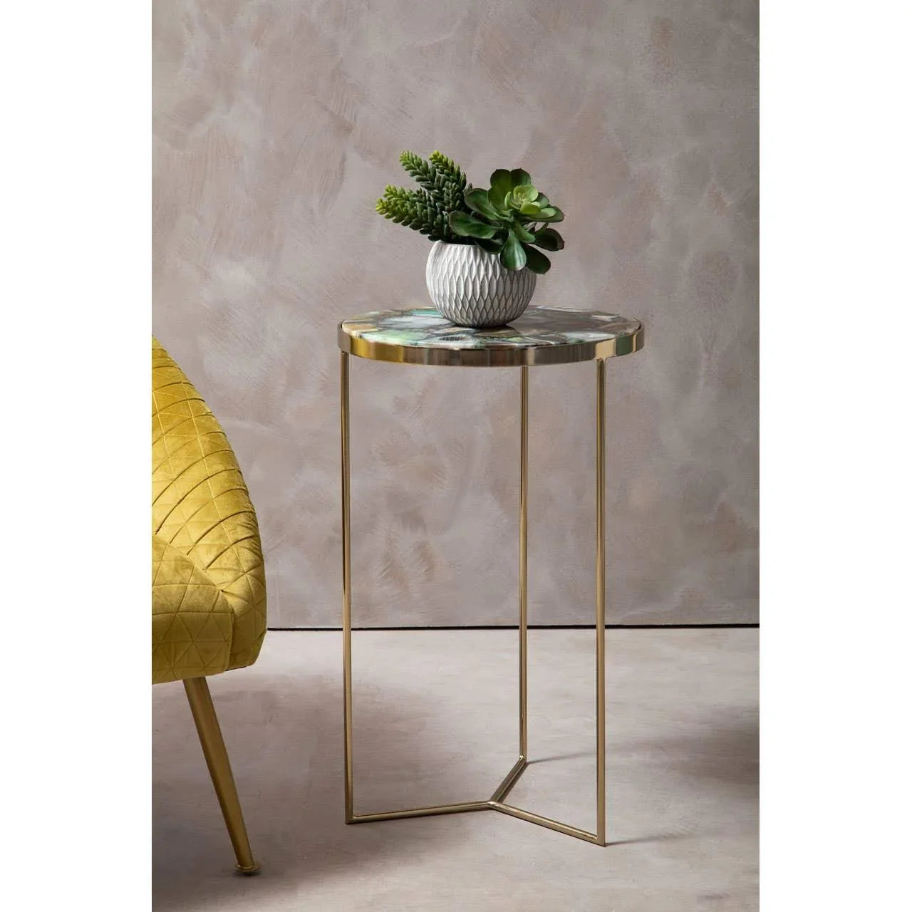 Round side table with gold metal legs and marble top, potted succulent decor on tabletop