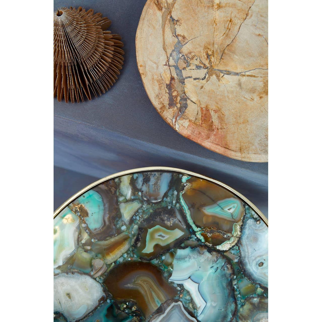 Round agate side table with gold trim and natural wood tray on grey surface