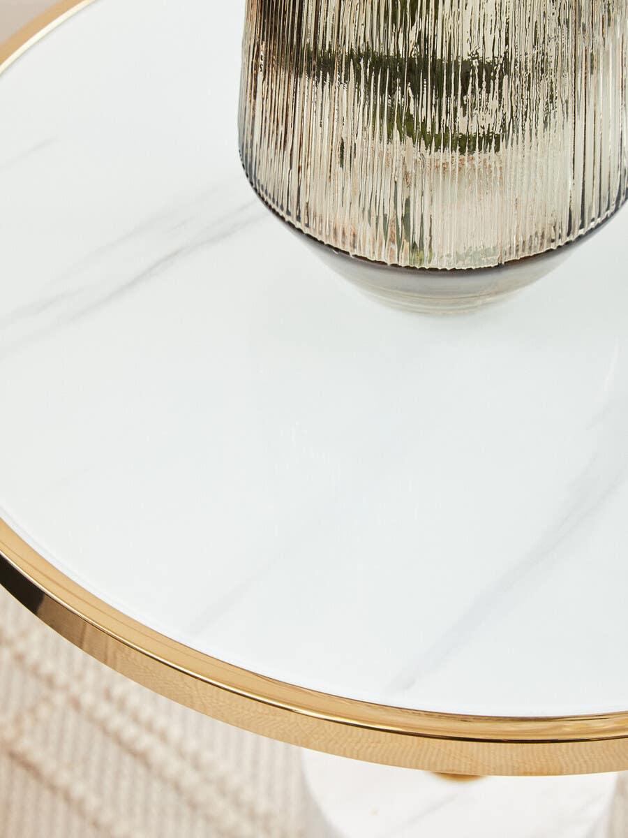 Round marble side table with gold trim and glass vase detail
