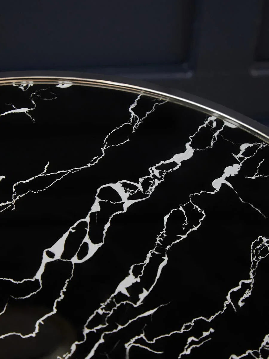 Black marble effect tabletop with white veining detail and silver rim edge