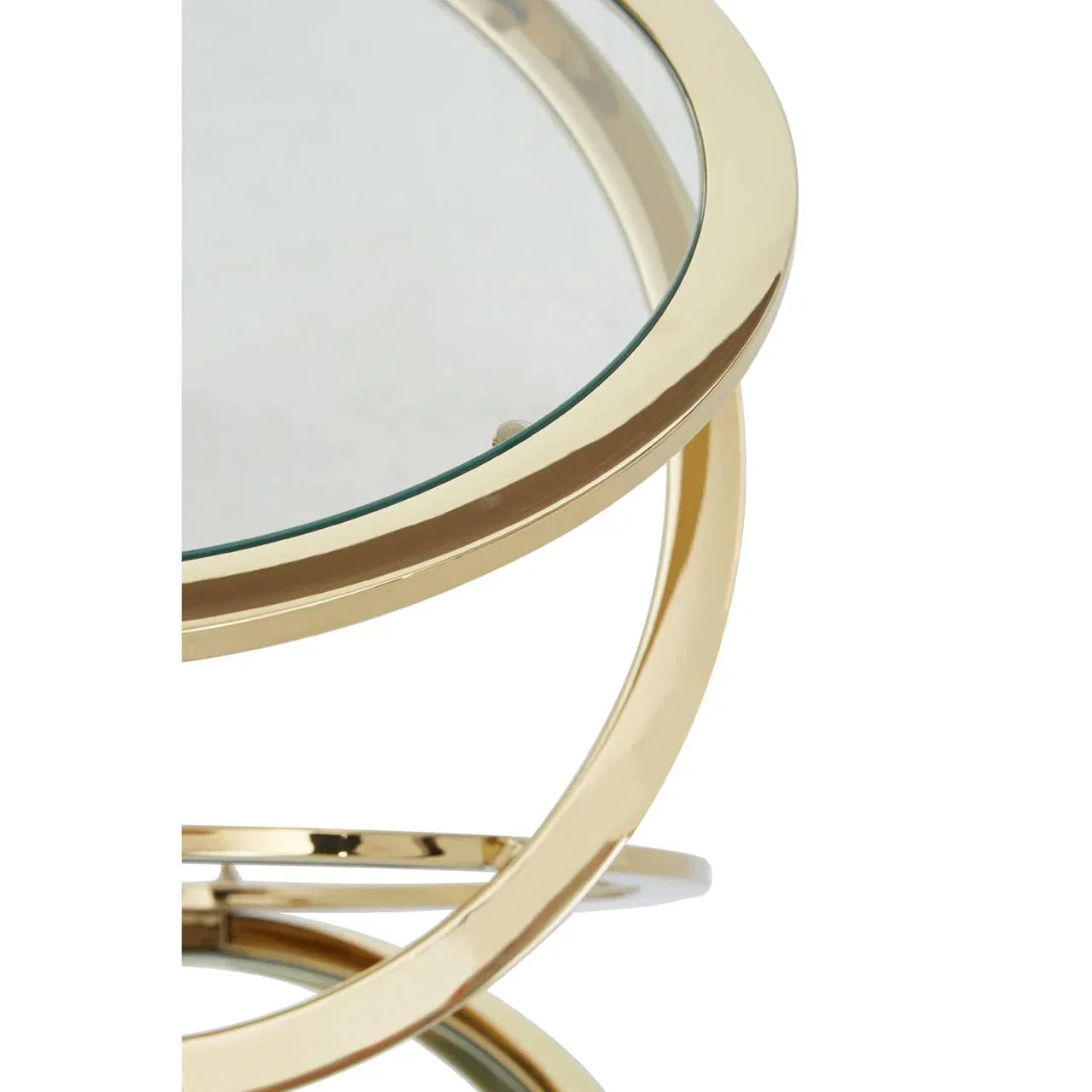 Close view of round glass coffee table with gold metal frame and modern design