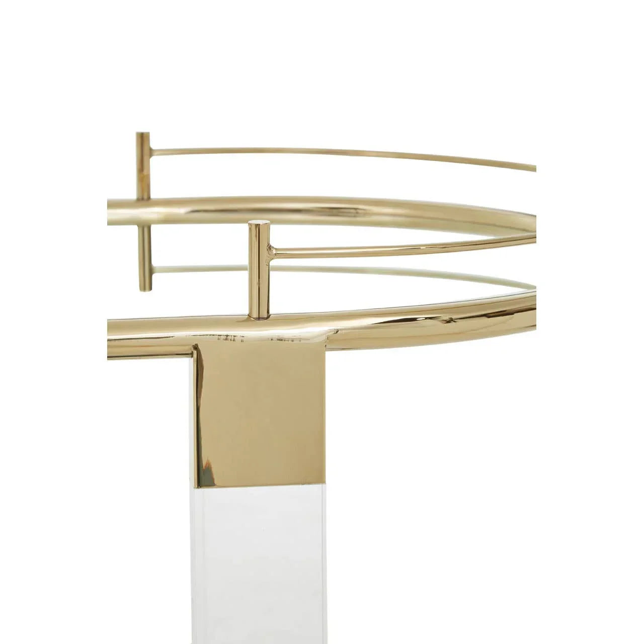 Close-up of gold metal and clear acrylic side table frame with modern geometric design