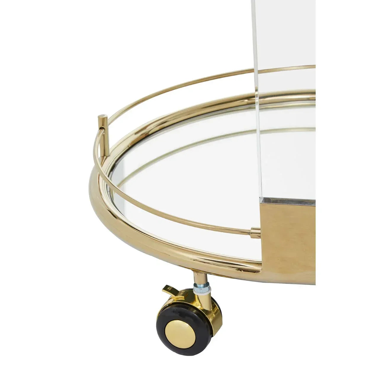 Gold metal bar cart with mirrored glass shelf and caster wheel, close-up view