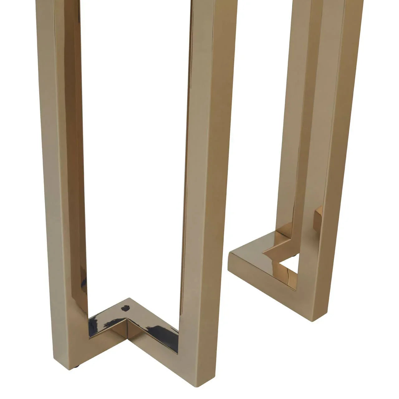 Gold metal table legs with geometric design and polished finish, close-up view